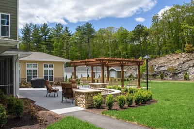 Outdoor seating area with a pergola and greenery