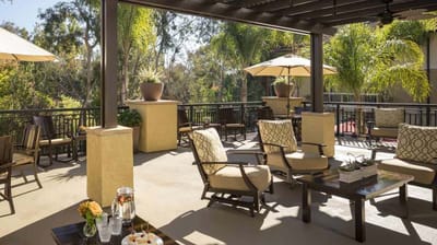 Outdoor seating area with umbrellas and greenery