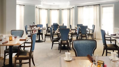 Dining room setup with empty tables and chairs