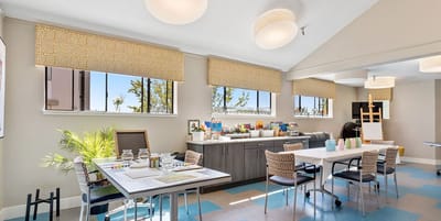 Bright activity room with tables and art supplies