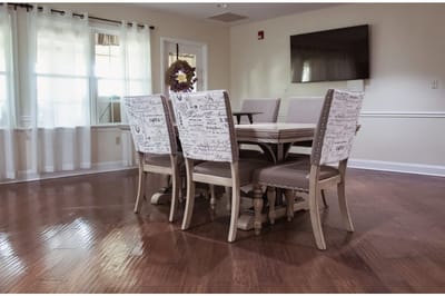 Brightly lit dining area with wooden table and chairs