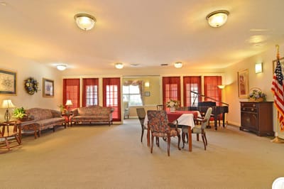 Bright common area with seating and a piano