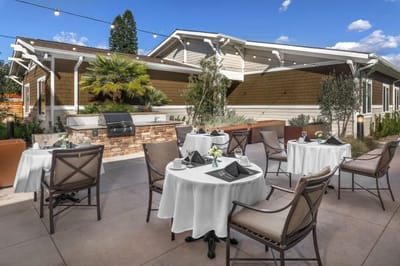 Outdoor dining area with white tablecloths