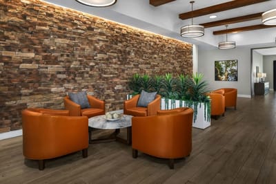 Cozy common area with comfortable seating and stone wall decor