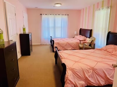 Two shared beds in a brightly decorated room