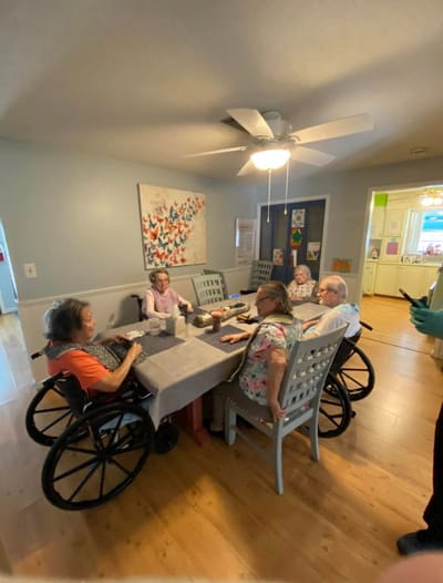 Residents engaged in a group activity around a table
