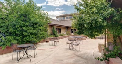 Outdoor patio area with seating and greenery