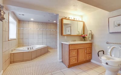 Well-lit bathroom with a bathtub and vanity