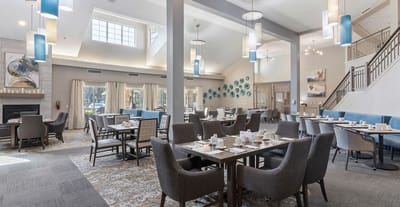 Bright and spacious dining room with tables and chairs
