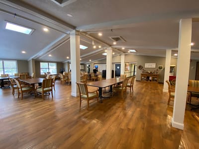 Bright interior dining room with wooden tables and chairs