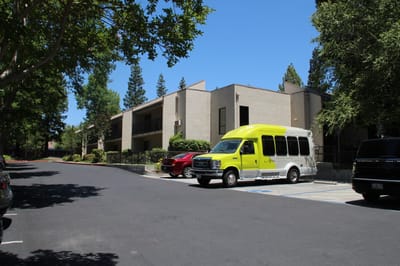 Building exterior with facility transport vehicle and cars