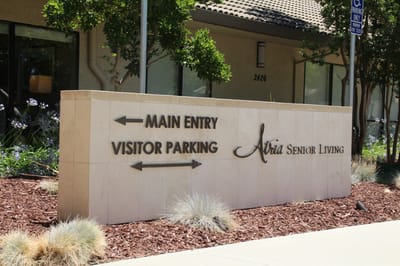 Sign directing to main entry and visitor parking
