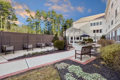Outdoor garden seating area with benches and landscaping
