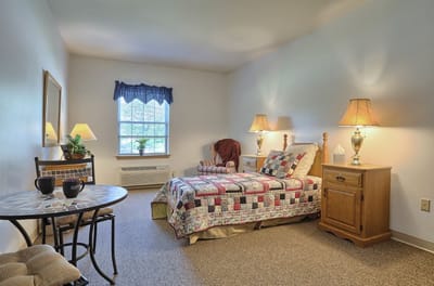 Cozy private resident room with quilted bed
