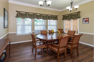 A dining room set up with a large table and chairs