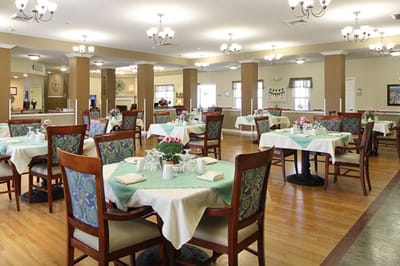 Bright dining room with tables set for residents