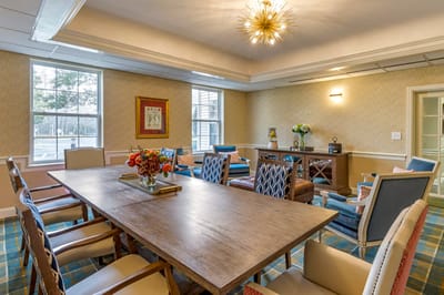 Bright common area with seating and a large table