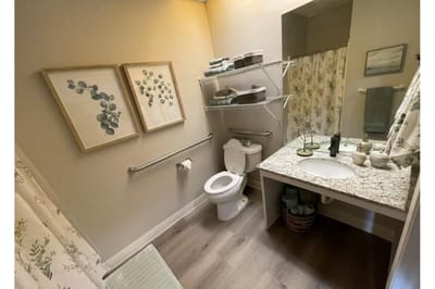 Well-decorated bathroom with floral artwork
