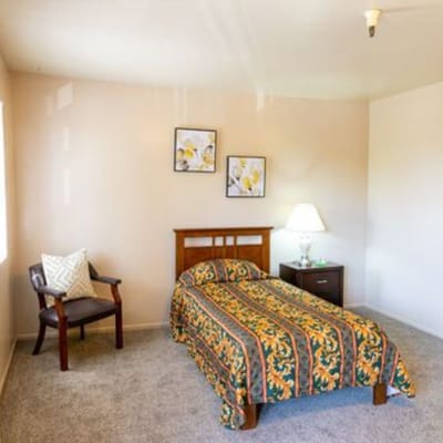 Cozy private resident room with bed and decor