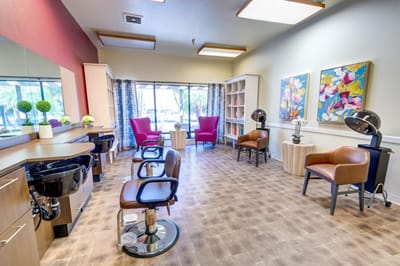 Interior view of a salon with chairs and artwork