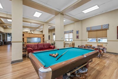 Game room with a pool table and seating area