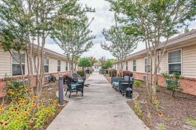Pathway lined with seating and plants at the facility