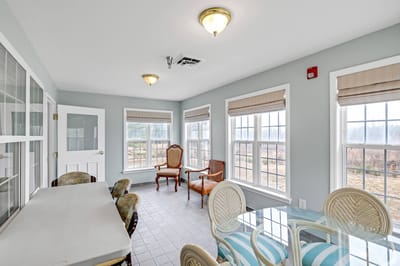 Bright common area with large windows and seating