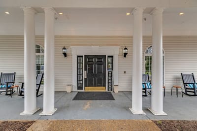 Front entrance of Spring Oak at Warrenton with rocking chairs