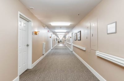 Empty hallway with beige walls and framed pictures