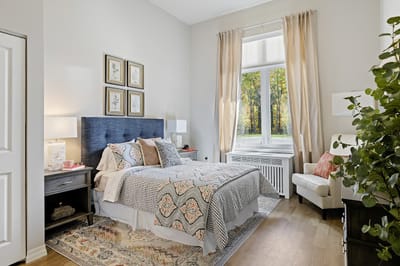 A bright and cozy resident bedroom with a view