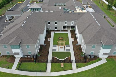 Aerial view of the senior living facility with garden