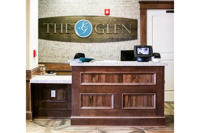 Reception area with wooden desk and facility sign