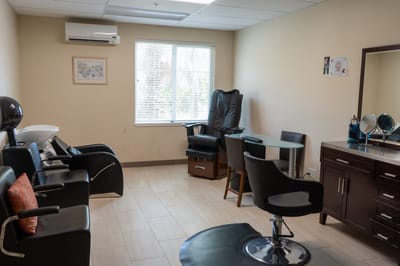 Interior view of a salon area with chairs and mirrors
