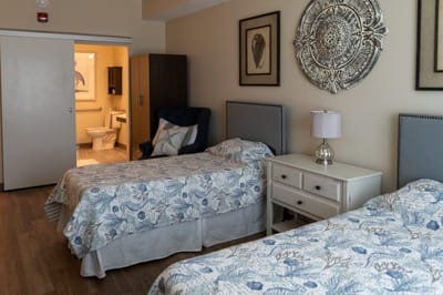A well-furnished shared bedroom in a senior living facility