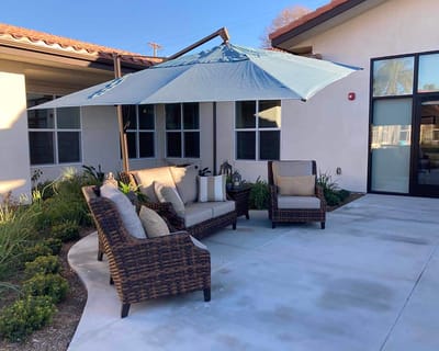 Outdoor seating area with a shade umbrella