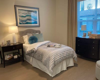 Cozy interior of a private resident room with bed and decor