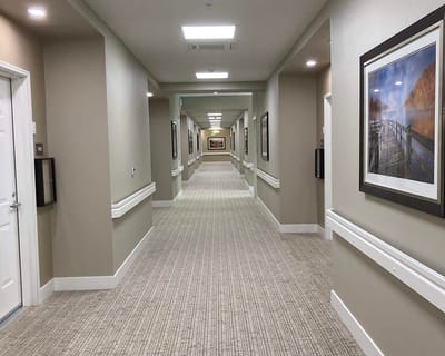 Interior hallway with framed pictures and neutral colors