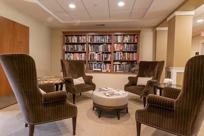 Cozy lounge area with bookshelves and comfortable seating