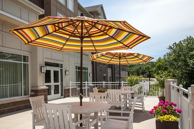 Patio area with colorful umbrellas and flowers