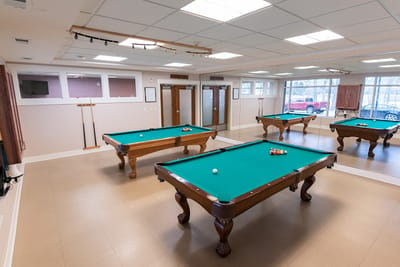 Interior view of a game room with pool tables