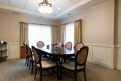 A bright common area with a large table and seating