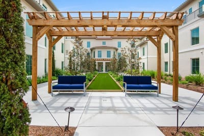 Outdoor seating area with a pergola and landscaped garden