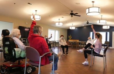 Residents participating in an exercise activity in a common room