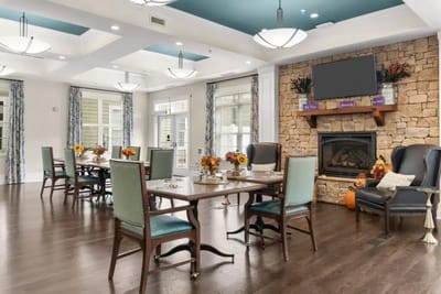 Bright dining room with tables and floral centerpieces