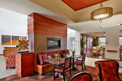 Interior common area with colorful seating and a fireplace