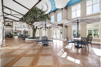 Bright common area with seating and umbrellas