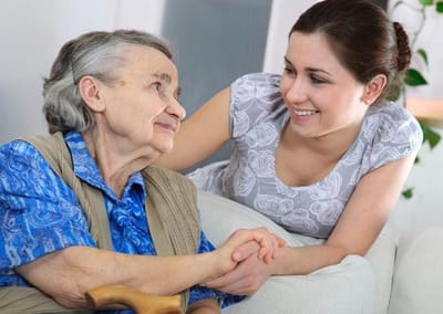 A caregiver and resident sharing a moment indoors
