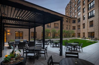 Outdoor courtyard with seating and greenery