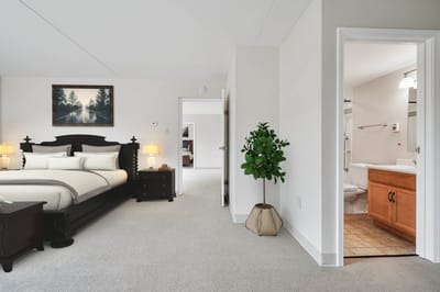 Interior view of a private resident room with a bed and bathroom