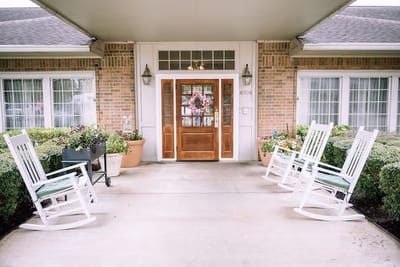 Entrance of an assisted living facility with rocking chairs